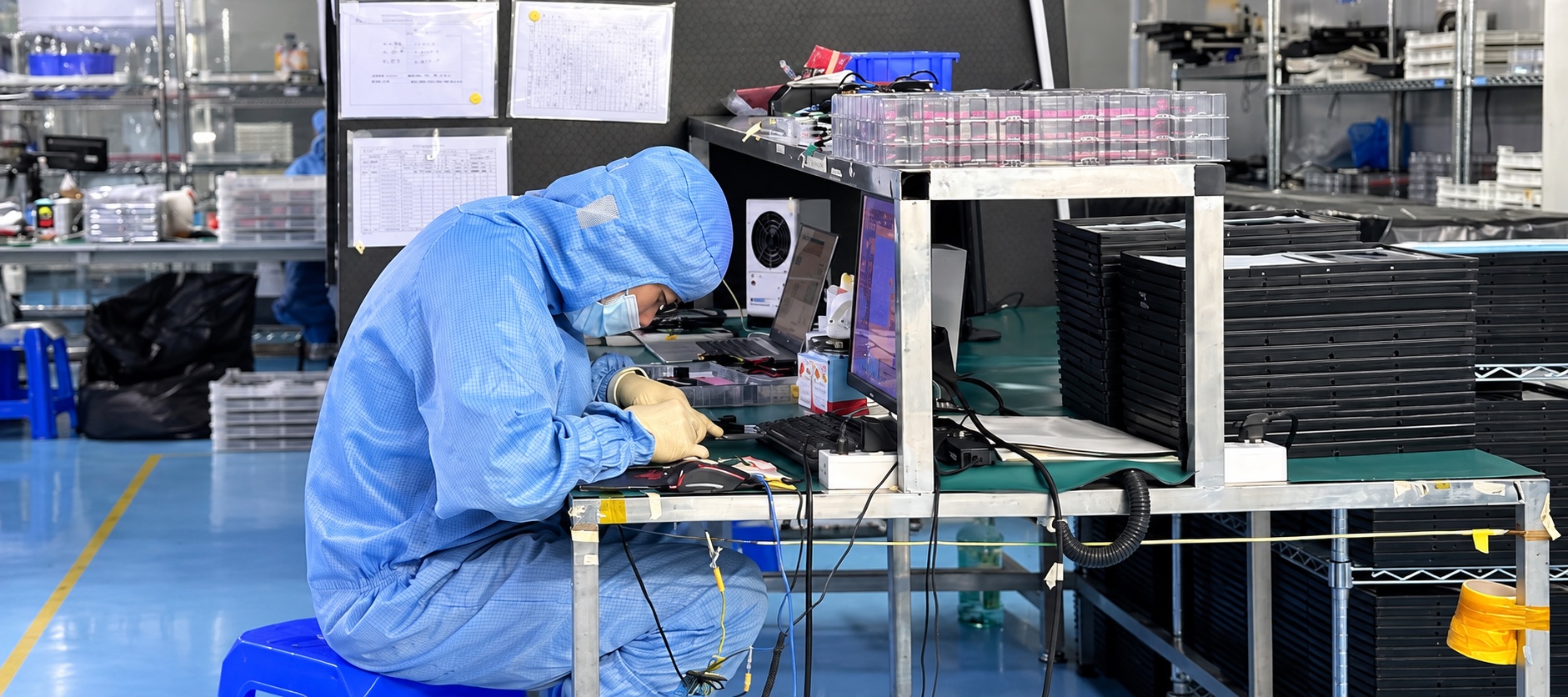 Technician checking a touch panel at a test workstation